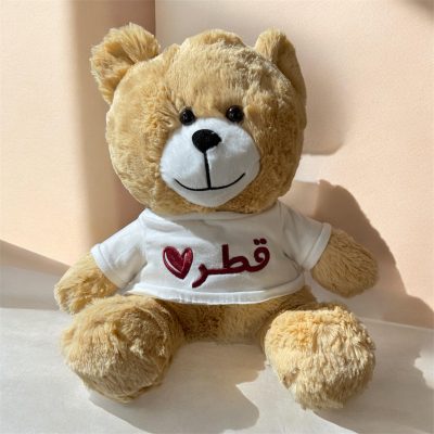 Crafted with exceptional softness and attention to detail, this charming teddy bear is designed to deliver comfort and style. Dressed in a refined white T-shirt embroidered with “قطر” and a heart motif, it represents a beautiful blend of warmth and cultural pride. A perfect keepsake or gift, ideal for those who appreciate meaningful and stylish pieces.